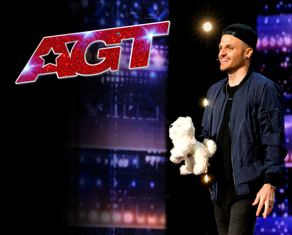 America's Got Talent winner Dustin Tavella holding a fake white puppy