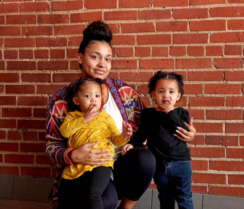 A woman and her two young daughters at city rescue mission